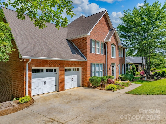 357 Lentz Landing Ln, Nebo, NC 28761 - view of front of home with driveway, an attached garage, a shingled roof, and brick siding