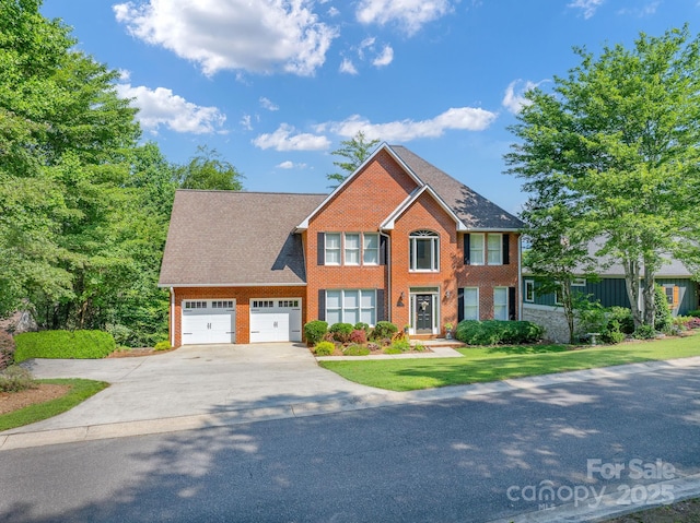 357 Lentz Landing Ln, Nebo, NC 28761 - colonial house with concrete driveway, brick siding, a garage, and a front yard