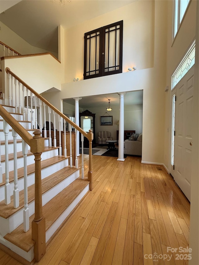 357 Lentz Landing Ln, Nebo, NC 28761 - entrance foyer with decorative columns, a high ceiling, hardwood / wood-style flooring, and stairway