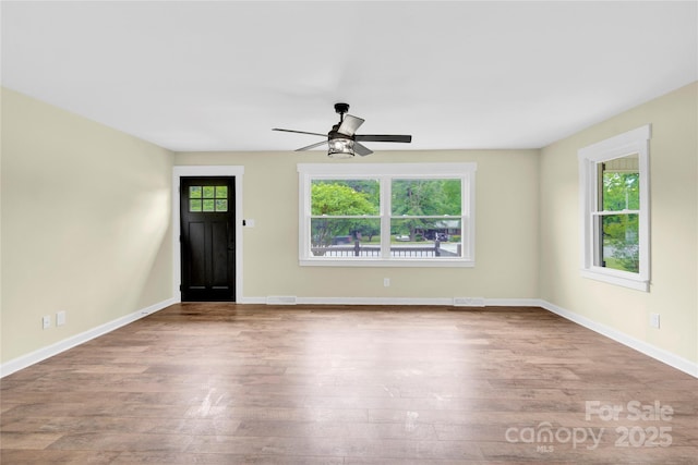 1501 E Church St, Cherryville, NC 28021 - unfurnished living room with healthy amount of natural light and wood finished floors
