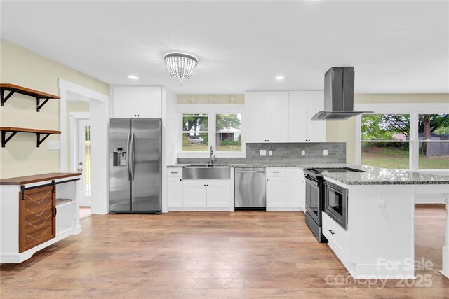 1501 E Church St, Cherryville, NC 28021 - kitchen featuring appliances with stainless steel finishes, a sink, island range hood, a peninsula, and white cabinetry