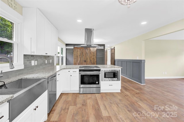 1501 E Church St, Cherryville, NC 28021 - kitchen with appliances with stainless steel finishes, a peninsula, island range hood, backsplash, and a sink