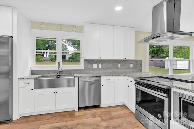 1501 E Church St, Cherryville, NC 28021 - kitchen with stainless steel appliances, wall chimney range hood, a sink, light wood-style floors, and light stone countertops
