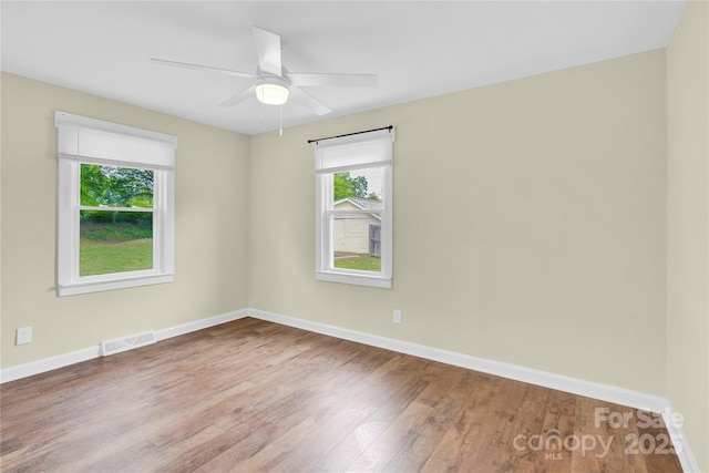 1501 E Church St, Cherryville, NC 28021 - empty room with wood finished floors, plenty of natural light, baseboards, and ceiling fan
