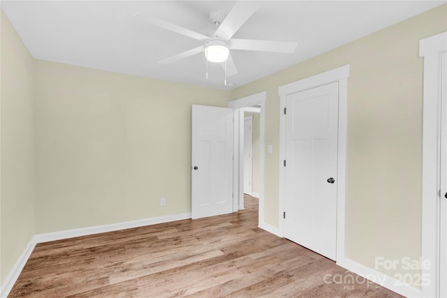 1501 E Church St, Cherryville, NC 28021 - unfurnished bedroom featuring wood finished floors, baseboards, and a ceiling fan