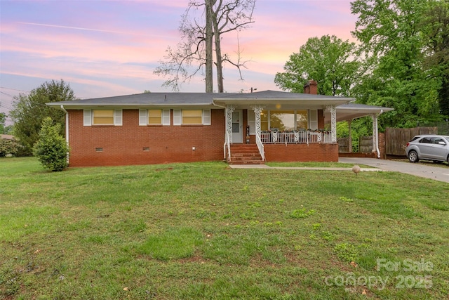 view of front of property featuring crawl space, a porch, brick siding, a chimney, and concrete driveway