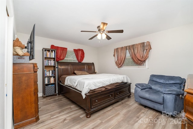 bedroom with light wood-style flooring, baseboards, and a ceiling fan