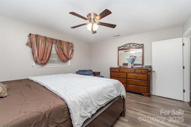 bedroom with wood finished floors and a ceiling fan