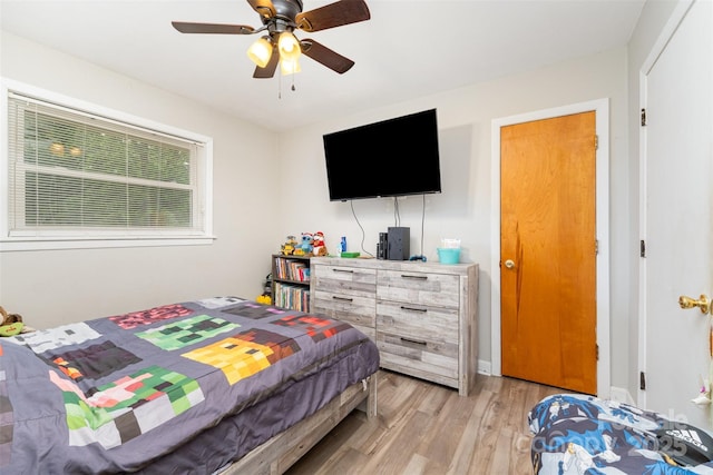 bedroom featuring light wood finished floors and ceiling fan