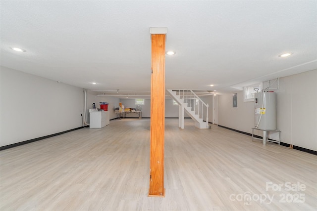 basement with water heater, light wood finished floors, washer and clothes dryer, stairway, and recessed lighting