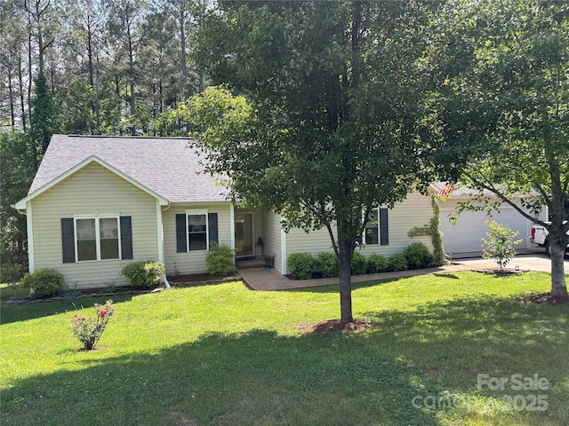 view of front facade with a front yard, a shingled roof, driveway, and an attached garage