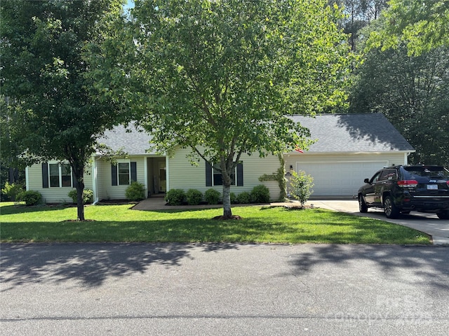 obstructed view of property featuring an attached garage, a front lawn, and driveway
