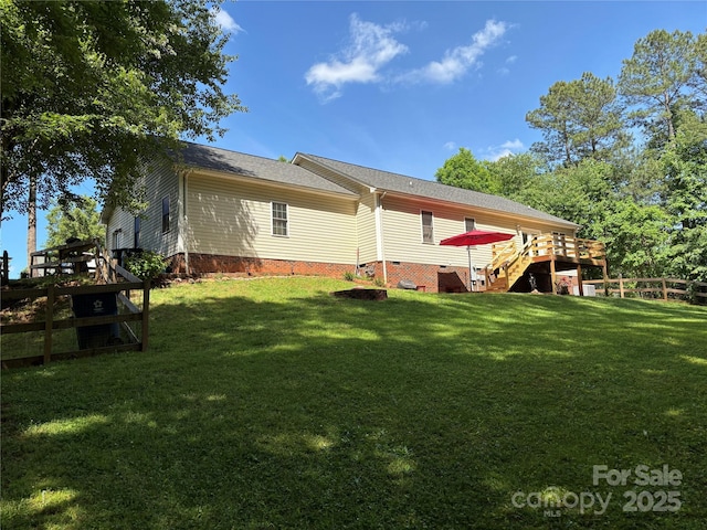 back of property with crawl space, a wooden deck, a shingled roof, and stairway