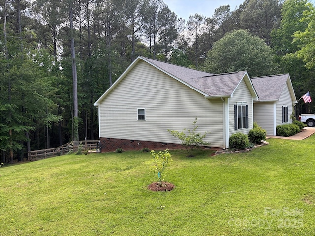 view of property exterior with crawl space and roof with shingles