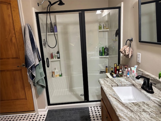 bathroom featuring a shower stall and vanity