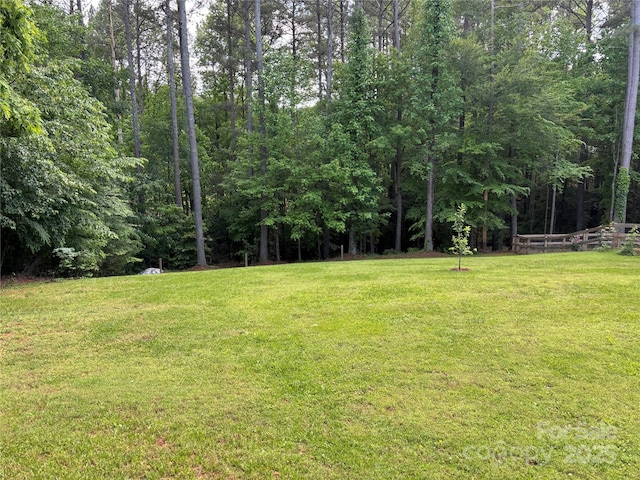 view of yard featuring a forest view