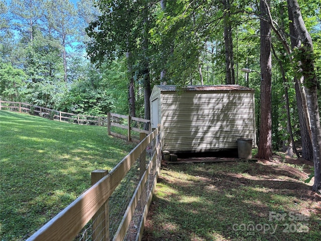 view of yard featuring a shed and an outbuilding