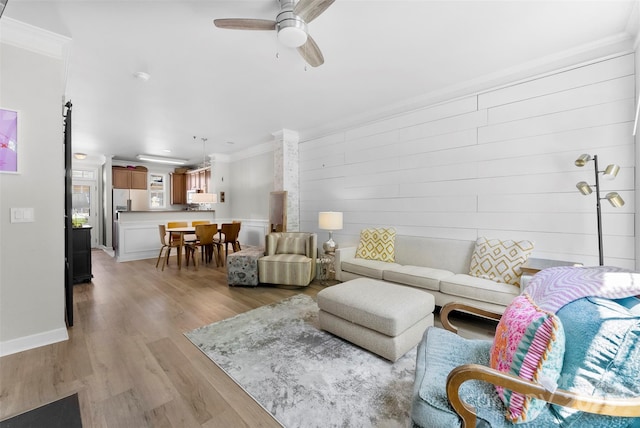 2485 Shanklin Ln, Denver, NC 28037 - living room with crown molding, light wood-style flooring, a ceiling fan, and baseboards