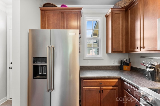 2485 Shanklin Ln, Denver, NC 28037 - kitchen with appliances with stainless steel finishes, dark countertops, brown cabinets, and crown molding