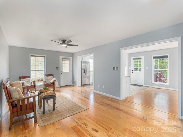 2600 Crabtree Rd, Waynesville, NC 28785 - living room featuring light wood-style flooring, baseboards, and a ceiling fan
