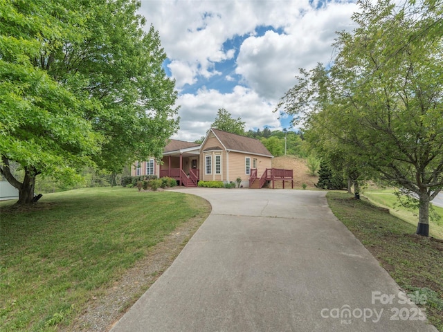 2600 Crabtree Rd, Waynesville, NC 28785 - ranch-style home featuring concrete driveway, a front yard, a porch, and stairway
