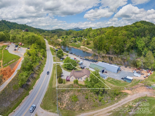2600 Crabtree Rd, Waynesville, NC 28785 - aerial view of property's location with property parcel outlined, a water and mountain view, and a heavily wooded area