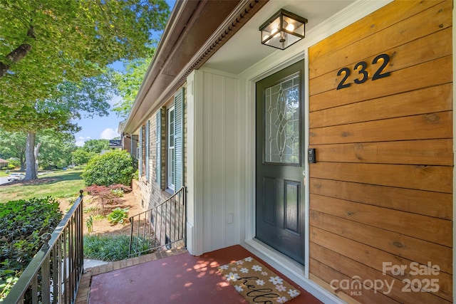doorway to property featuring board and batten siding