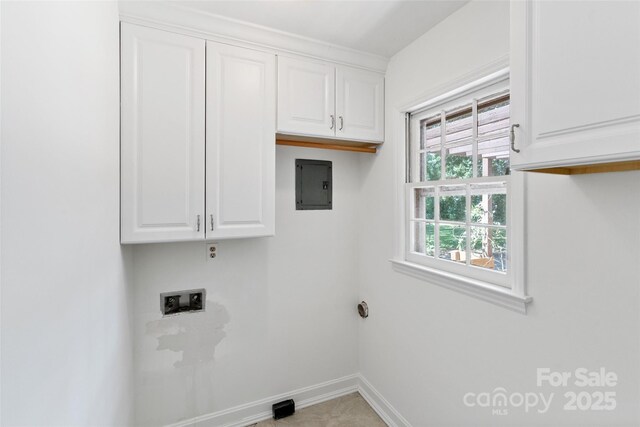 washroom featuring cabinet space, baseboards, hookup for a washing machine, and electric panel
