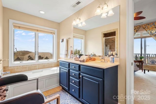 143 Wildflower Ln, Sugar Mountain, NC 28604 - bathroom featuring double vanity, ensuite bath, a garden tub, and a chandelier