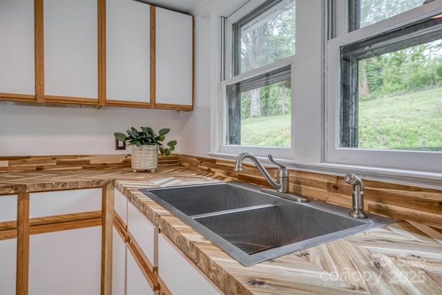 3614 Frank Whisnant Rd, Morganton, NC 28655 - kitchen featuring a sink, plenty of natural light, white cabinets, and butcher block counters