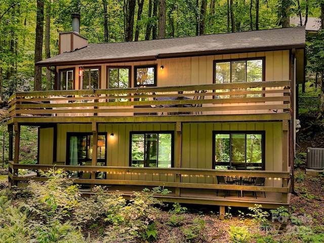 76 Shirley Dr, Maggie Valley, NC 28751 - back of property featuring a deck, a chimney, central air condition unit, and a shingled roof