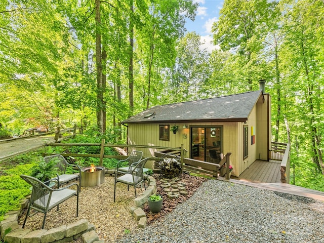 76 Shirley Dr, Maggie Valley, NC 28751 - back of property featuring an outdoor fire pit, a deck, and roof with shingles