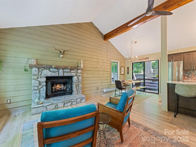 76 Shirley Dr, Maggie Valley, NC 28751 - living area with high vaulted ceiling, light wood-style floors, a fireplace, a chandelier, and ceiling fan