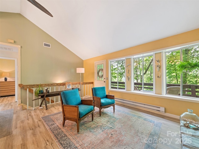 76 Shirley Dr, Maggie Valley, NC 28751 - living area featuring a baseboard radiator, wood finished floors, a ceiling fan, baseboards, and high vaulted ceiling