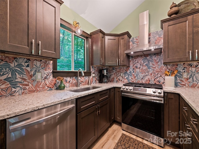 76 Shirley Dr, Maggie Valley, NC 28751 - kitchen with appliances with stainless steel finishes, wall chimney range hood, a sink, dark brown cabinetry, and light stone counters