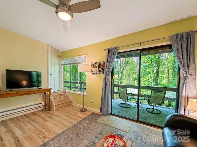 76 Shirley Dr, Maggie Valley, NC 28751 - entryway featuring a baseboard heating unit, baseboards, wood finished floors, vaulted ceiling, and ceiling fan