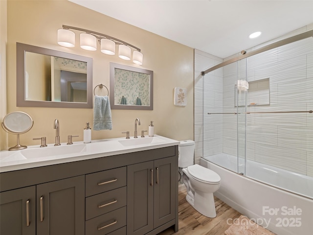76 Shirley Dr, Maggie Valley, NC 28751 - bathroom featuring double vanity, toilet, shower / bath combination with glass door, and wood finished floors