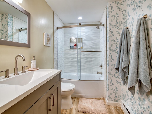 76 Shirley Dr, Maggie Valley, NC 28751 - full bathroom with wood finished floors, vanity, bath / shower combo with glass door, toilet, and a baseboard heating unit