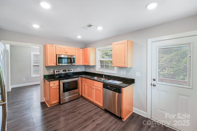 668 Smith St, Kannapolis, NC 28083 - kitchen featuring stainless steel appliances, light brown cabinetry, dark countertops, baseboards, and recessed lighting