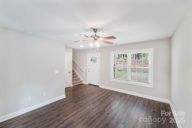 668 Smith St, Kannapolis, NC 28083 - unfurnished living room featuring baseboards, ceiling fan, dark wood-style floors, and stairs