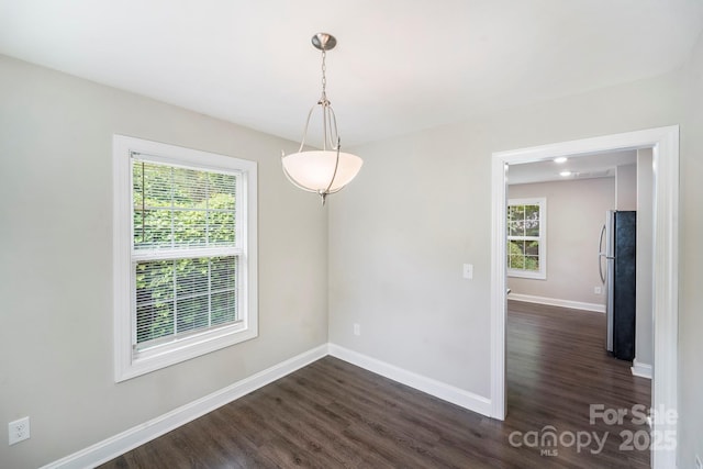 668 Smith St, Kannapolis, NC 28083 - spare room featuring dark wood-type flooring, healthy amount of natural light, and baseboards