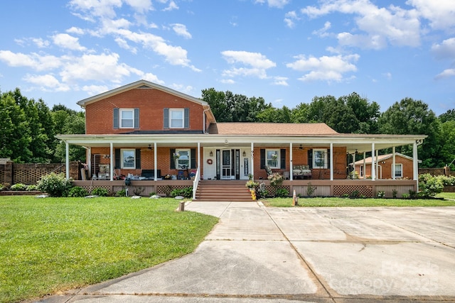907 Sikes Mill Rd, Monroe, NC 28110 - farmhouse inspired home with brick siding, a porch, and a front yard