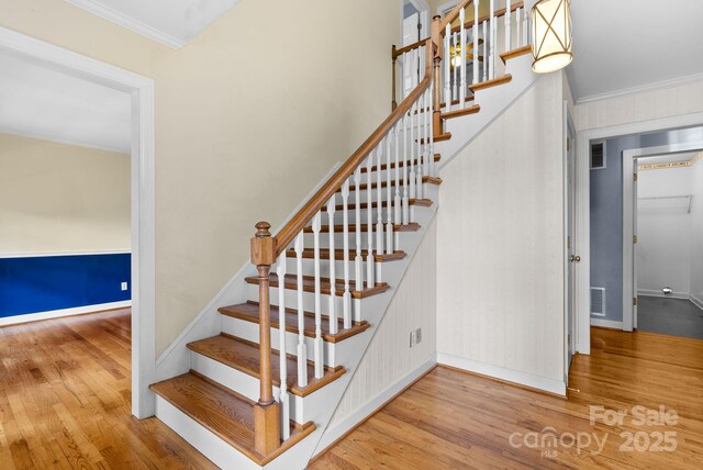304 La Foret Dr, Morganton, NC 28655 - stairs with wood finished floors, crown molding, and baseboards