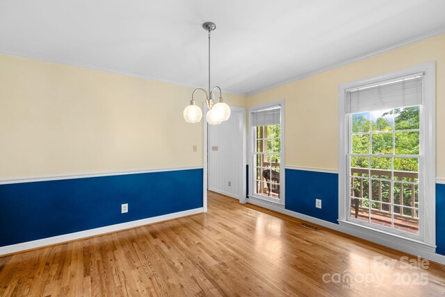 304 La Foret Dr, Morganton, NC 28655 - empty room with baseboards, ornamental molding, wood finished floors, and a chandelier