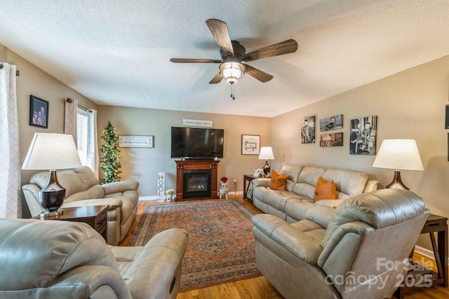 8520 Wright Rd, Kannapolis, NC 28081 - living room with wood finished floors, ceiling fan, a textured ceiling, a glass covered fireplace, and baseboards