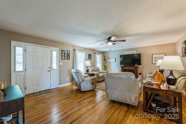 8520 Wright Rd, Kannapolis, NC 28081 - living room featuring wood finished floors, a ceiling fan, a textured ceiling, and baseboards
