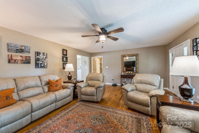 8520 Wright Rd, Kannapolis, NC 28081 - living area featuring wood finished floors, ceiling fan, baseboards, and a textured ceiling