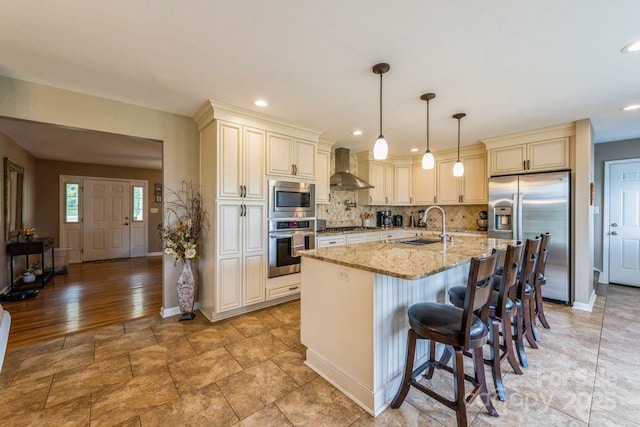 8520 Wright Rd, Kannapolis, NC 28081 - kitchen featuring stainless steel appliances, cream cabinets, wall chimney range hood, a sink, and recessed lighting