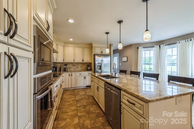 8520 Wright Rd, Kannapolis, NC 28081 - kitchen featuring stainless steel appliances, cream cabinetry, a sink, a kitchen island with sink, and decorative backsplash