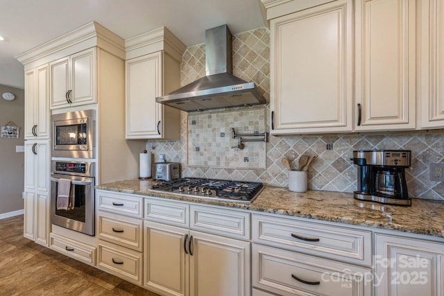 8520 Wright Rd, Kannapolis, NC 28081 - kitchen featuring appliances with stainless steel finishes, wall chimney exhaust hood, cream cabinetry, and decorative backsplash